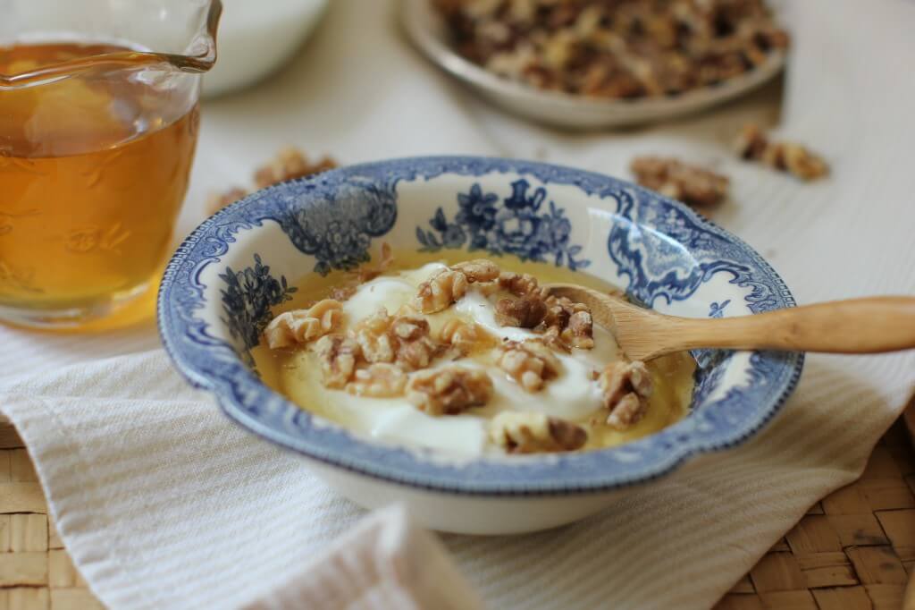 Greek Yogurt with nuts and honey in a bowl